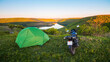 © O.Farion - Motorcycle traveling concept, camping with a tent, scenic nature landscape with canyon in the national nature park Podilski Tovtry, Studenytsia and Dnister river, Ukraine