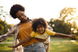 © liderina - African American mother and daughter playing in the park.