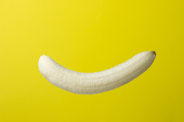 Poster - Banana on a yellow background. Bright fruit. Peeled banana on a colored background.