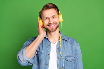 Sticker - Photo portrait of young guy listening music wearing headphones isolated vibrant green color background