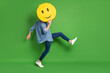 © deagreez - Full length body size side profile photo of man hiding face behind yellow smile isolated vivid green color background