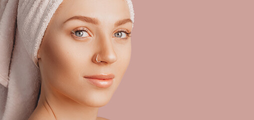 Wall Mural - beautiful sensual young girl with clean skin on a pink background with a mockup. topless woman in a 