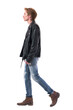 © sharplaninac - Side view of walking young man in leather jacket and jeans with boots. Full body length isolated on white background