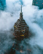 © AmazingAerialAgency - Aerial view of a skyscraper among the clouds in Shanghai financial district, Shanghai, China.
