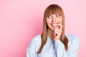 Poster - Portrait of attractive cheerful curious girl biting nail thinking copy space isolated over pink pastel color background