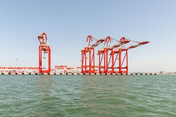 Large cargo cranes stand on a pier in the Mediterranean port of Haifa in Israel