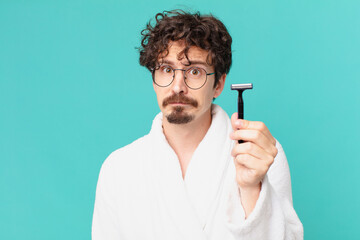 Poster - young crazy man shaving his beard with a razor