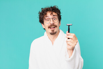 Poster - young crazy man shaving his beard with a razor