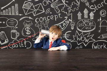 Wall Mural - Bright idea! Happy child student against blackboard