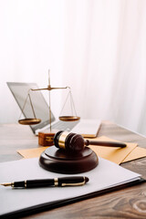 Wall Mural - Business and lawyers discussing contract papers with brass scale on desk in office. Law, legal services, advice, justice and law concept picture with film grain effect