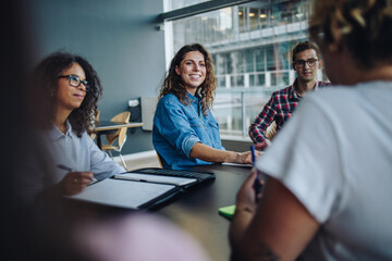 Confident businesswoman in boardroom meeting