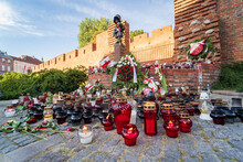 Warsaw Uprising Memorial Day, Flowers, Candles And Polish Flags Near Little Insurrectionist Sculpture, A Statue Of The Child Soldiers. Honoring Victims Of 1944 Revolt