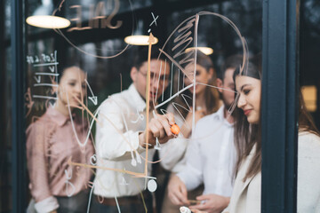 Wall Mural - Coworkers writing infographics during teamwork in conference room