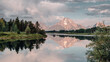 The morning sunrise illuminates Mt. Moran and the Teton Mountain Range a pink hue as they reflect on the Snake River at Oxbow Bend in Grand Teton National Park, WY, USA.