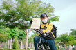© 2B - Bike delivery man staff happily staring at the camera while wearing a face mask.
