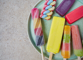 Sticker - colorful popsicles on grey stone surface