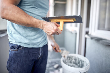 Wall Mural - Man working on a house facade.