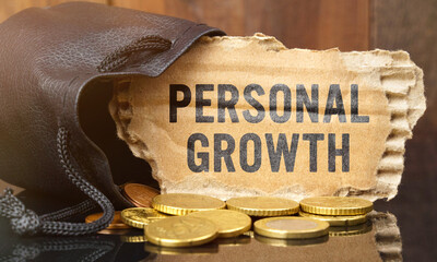 On the table is a bag of money from which sticks out cardboard with the inscription - PERSONAL GROWTH