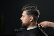 © Rabizo Anatolii - Low fade machine haircut for handsome bearded man in barbershop. Hair cut with a smooth transition.