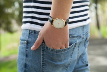 Caucasian man holding a watch. Hand watch. Outdoors.