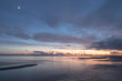 © Mati Kose - Coastal sunset view with the long-shutter silky smooth seawater and scenic sky with clouds and focus on the sandbar texture in the front