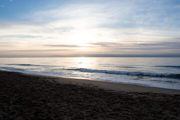 Canvas Print - Beautiful shot of foam waves hitting a sandy seashore