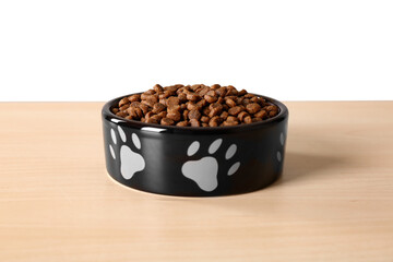 Wall Mural - Dry dog food in pet bowl on wooden surface