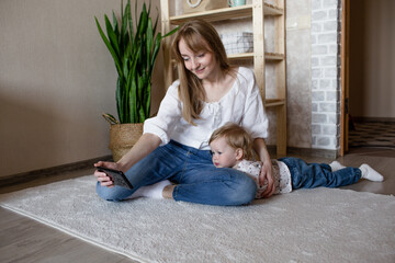 a happy and caring young mother plays with her little daughter. happily spend time with your child