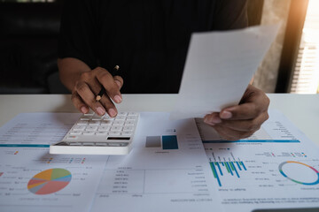 American african man is managing, calculating the debt and holding cost bill.