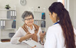 © Studio Romantic - Cheerful senior lady discussing course of treatment with her doctor. General practitioner and mature woman talking and looking at each other during interview in medical office of clinic or hospital