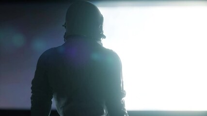 Wall Mural - alone astronaut looking at the huge illuminator of an unknown spaceship interior