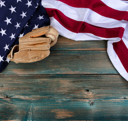 Wall Mural - US flag with American baseball and glove on faded blue wooden planks for sport concept