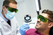 © Kostiantyn - Patient and doctor in glasses during laser dental treatment