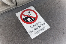 Red White Prohibition Sign Painted On The Asphalt, German Text Sign,german Text Translation: Jumping From The Bridge Prohibited