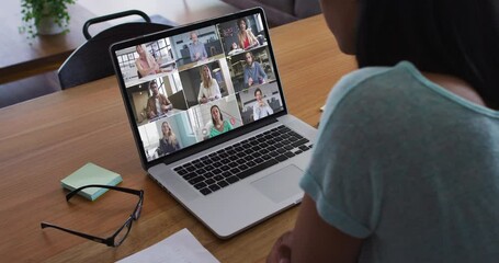 Poster - African american woman having a video conference with office colleague on laptop at home