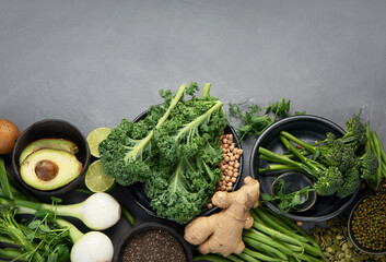 Wall Mural - Assorted green vegetables and cereal on gray background. Healthy food concept.