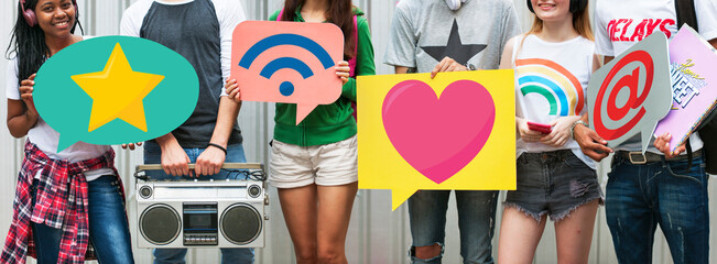 Teens holding social media icons