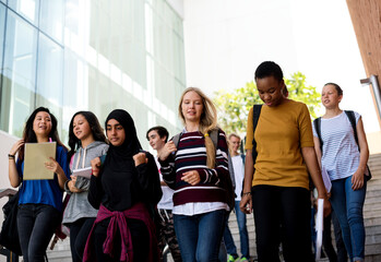 Wall Mural - diverse group of students walking in school