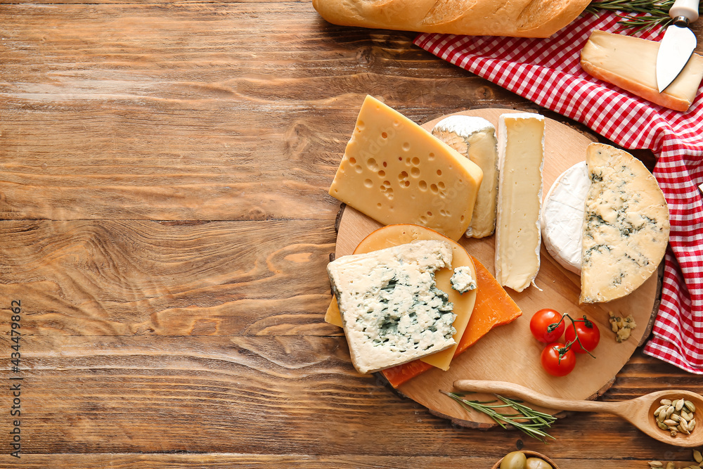 Composition with different types of cheese on wooden background