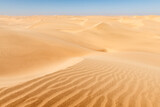 Fototapeta  - Orange sand dunes and clear sky in Namib desert