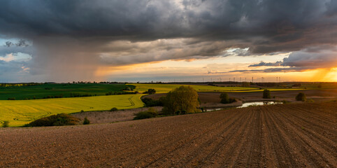 Wall Mural - evening storm at sunset over the beautiful rural areas