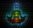 Glowing aura and chakras on meditating figure in yoga lotus pose