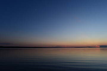 Wall Mural - Twilight blue sky with a glow young moon