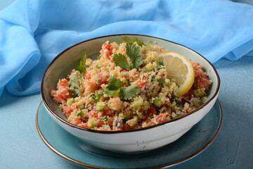 Wall Mural - Tabbouleh - a Middle Eastern cuisine vegetarian salad with chopped parsley, tomatoes, mint, onion and bulgur, and seasoned with olive oil, lemon juice.