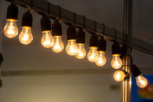 Light Bulbs Hanging In A Row With Warm Light