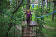 © kichigin19 - extreme vacation, girl in a yellow helmet rope park active holidays in the forest