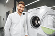 © fotofabrika - Young man choosing new washing machine in household appliances store