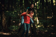 © Zoran Zeremski - Young couple enjoys together walking through the forest.