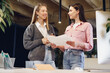 © fotofabrika - Two young women working together in office