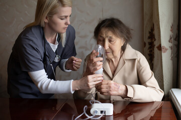 Wall Mural - Young Female Doctor Holding Oxygen Mask Over Senior woman Patient's Face